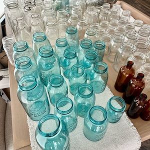 Various vintage mason jar, milk bottles, and bottles.